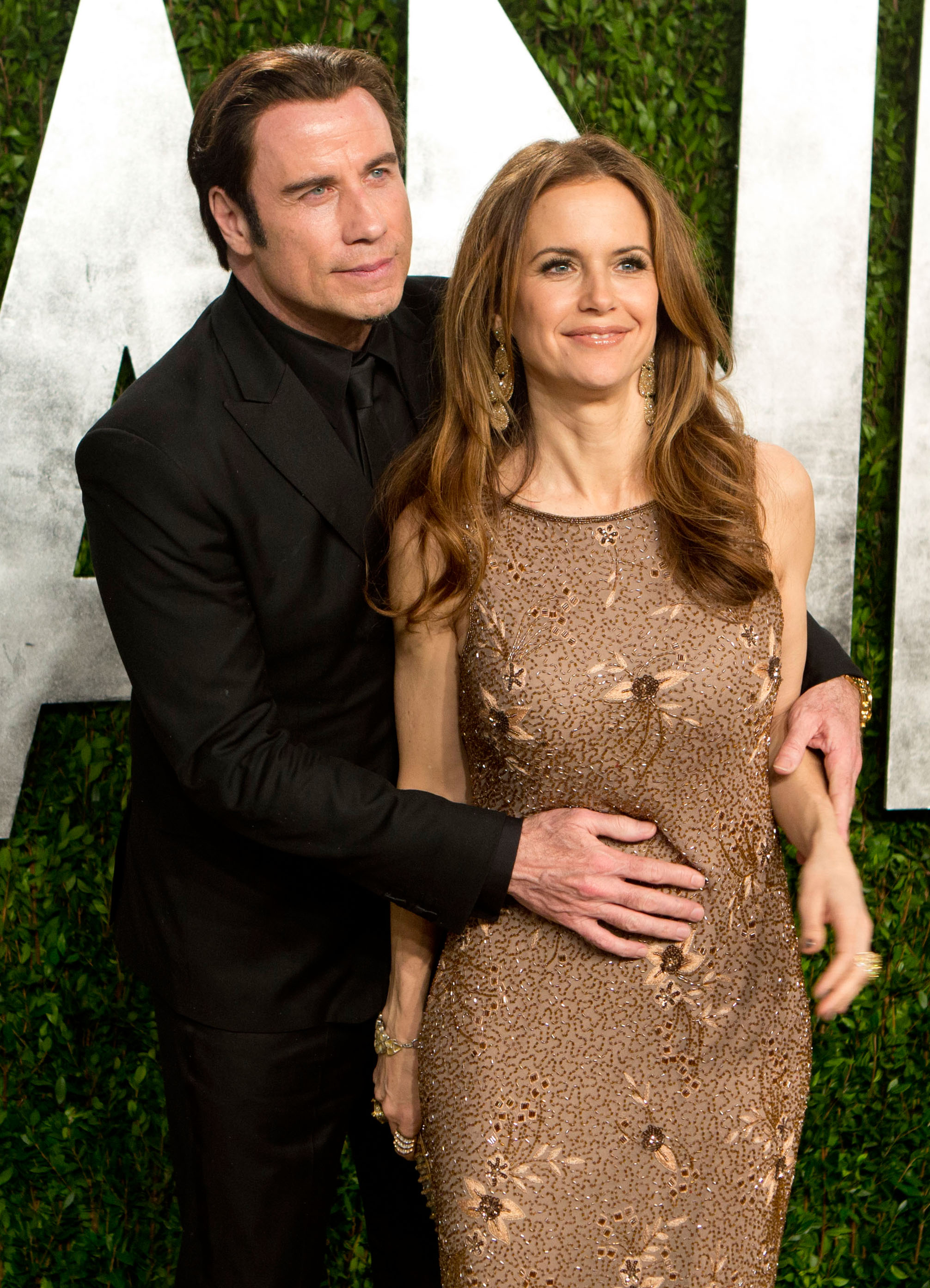 John Travolta embraced wife Kelly Preston on the red carpet. Vanity