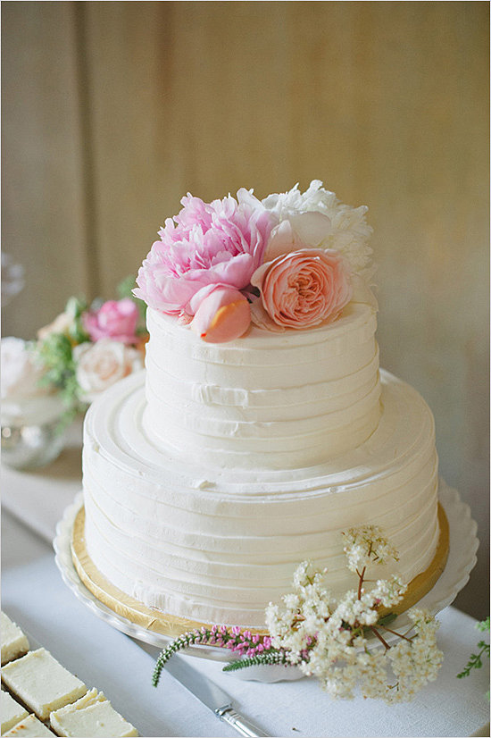 Top a buttercreamcovered cake with pretty flowers, and
