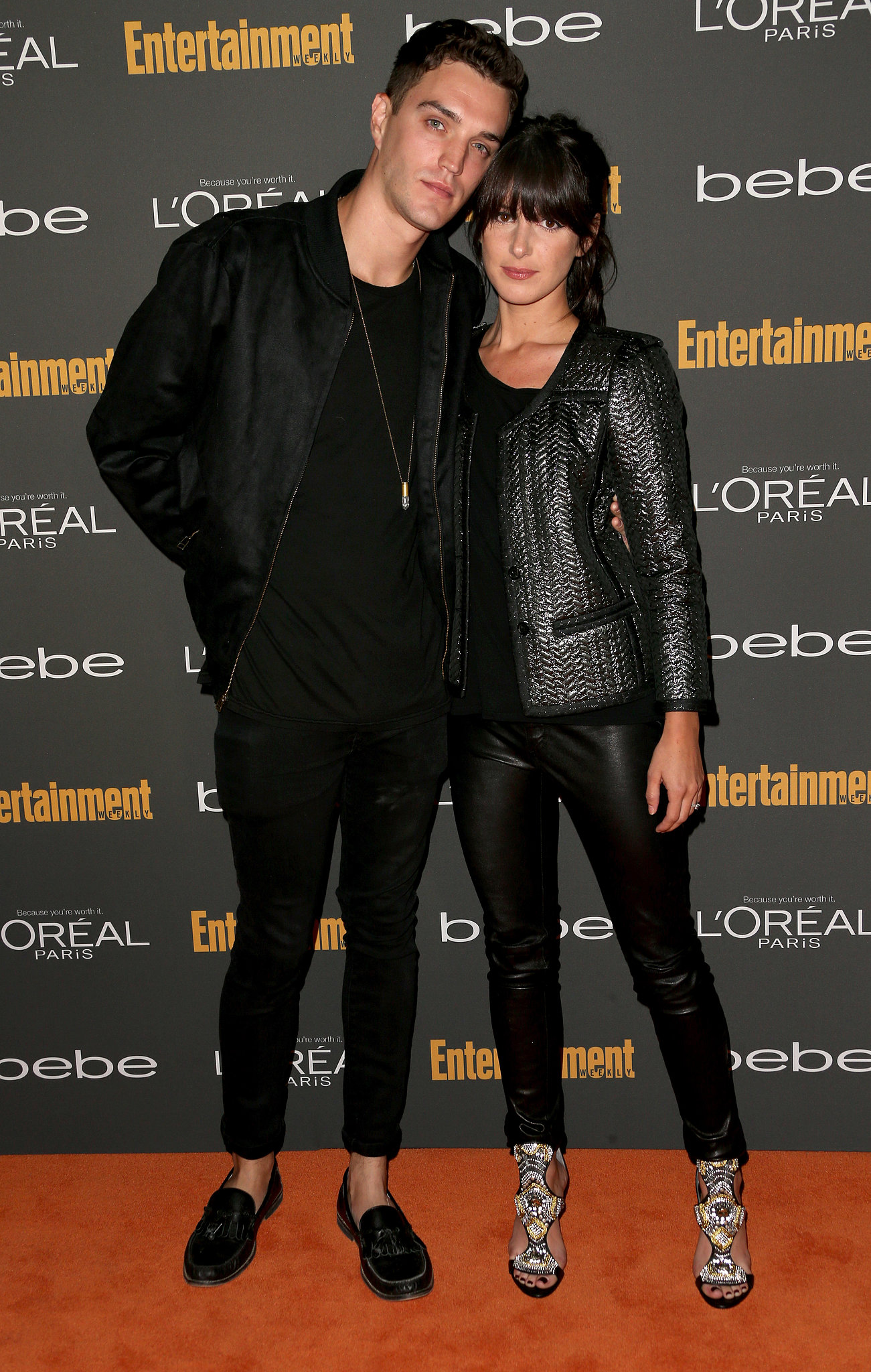 Shenae Grimes posed with her husband in a black leather jacket, | The