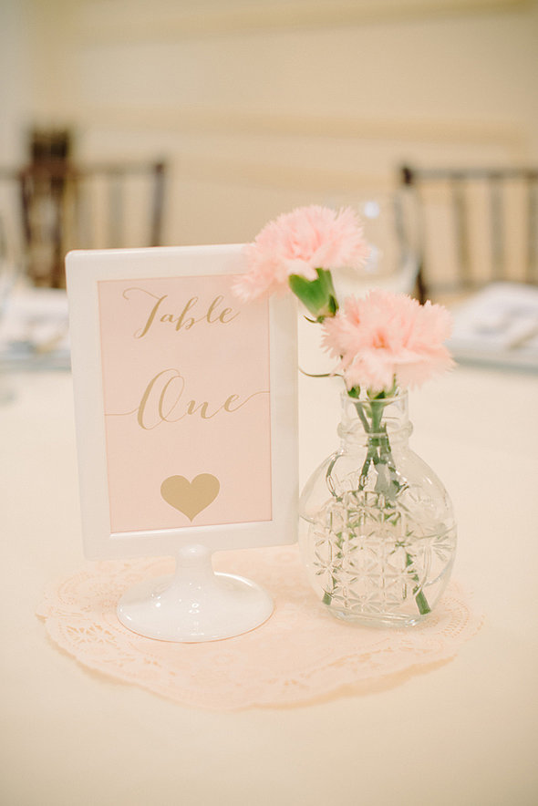 On the tables were pink and gold table numbers in white pedestal A