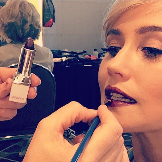 POPSUGAR Australia: How did you get your skin ready before the red carpet? Anna Bamford: I always make an extra effort with my skincare in the lead up to a big event. I use the ModelCo Exfoliating Cream Scrub ($20) and the ModelCo Instant Miracle Booster ($35) which makes my skin really glow! Then I always use ModelCo Rosehip Oil ($20) on my skin for hydration — it is amazing! For my body, I always exfoliate but on Thursday night I prepped my skin with a meduim self-tan and made sure I packed my ModelCo Tan Airbrush in a Can ($22) for a last minute bronzed glow. PS: What did you do to get your hair ready?  AB: I always take really good care of my hair but before leaving for Melbourne I got my hair coloured at Valonz in Sydney — they always do such a great job. I wanted to go quite blonde to contrast the dress so made sure I used a protein treatment on my hair leading up to the appointment so it was really nourished and strong. PS: What makeup and nail polish have you chosen for tonight? AB: Last year I kept my look quite pretty and innocent and this year I wanted to glam it up a bit and go for a sexier look. My dress is black so I didn't want to go for a bright red as I wanted it to blend instead of stand out so I thought a deep plum was the perfect colour. I wanted to go for a sexier edgier look so my makeup is going to be a bold lip, I'm wearing ModelCo Party Proof Lipstick in Purple Sangria ($18). Then I'll definitely be using a liquid eyeliner and ModelCo's Fibre Lash Mascara ($36) for a simple but striking eye. PS: How does your look work back with your dress? AB: My gown has quite a high cut neck so I've decided to wear my hair in some sort of up 'do to show off all of the dress . . . the dress is quite modern with clean lines so I want to keep my makeup modern with a statement lip.