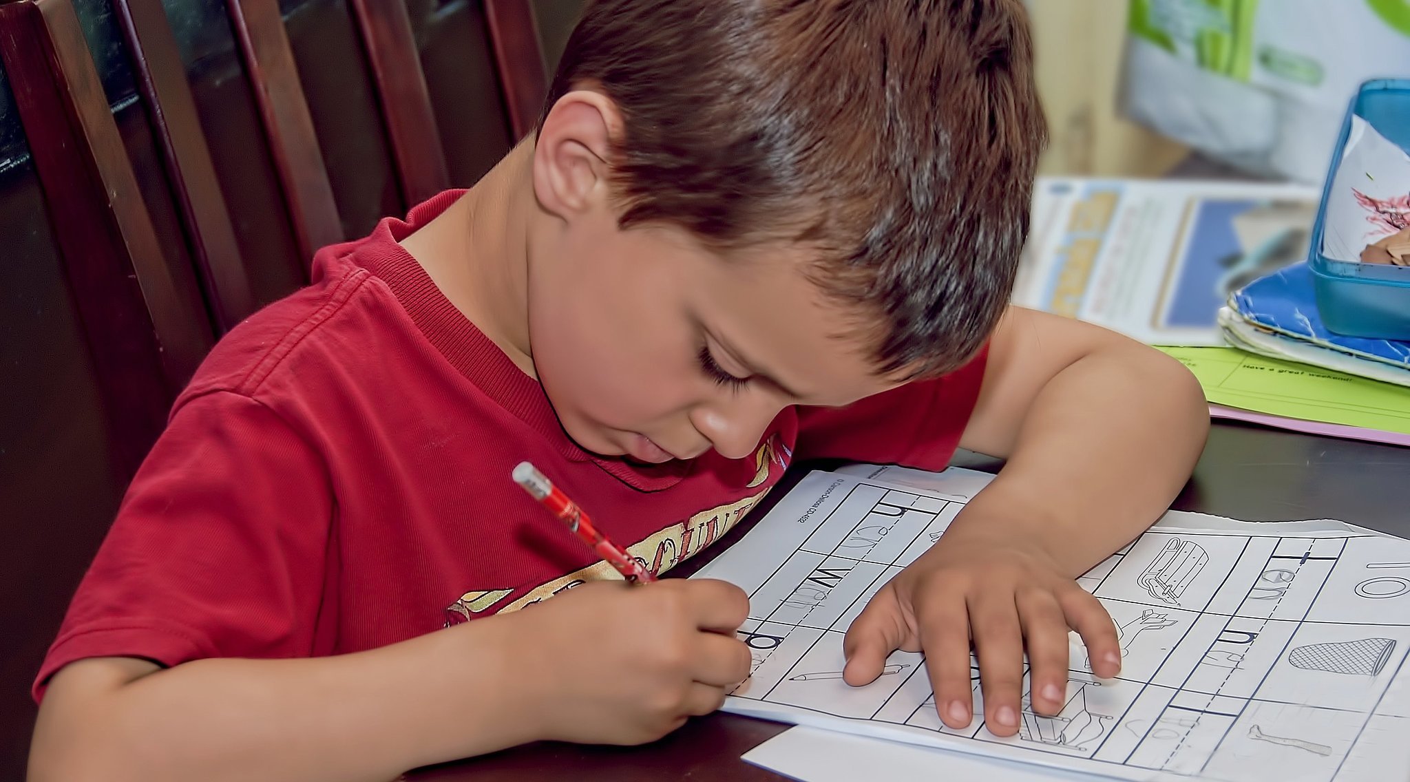 video of little boy doing math homework